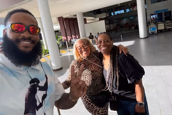 Happy travelers arriving at Seychelles airport for a private transfer, showcasing a seamless travel experience.