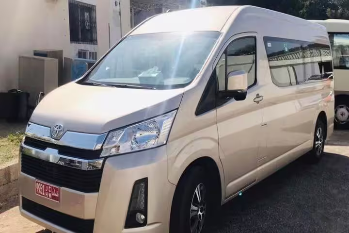 Spacious private transfer van for comfortable travel from Muscat to Wadi Shab, featuring modern amenities.