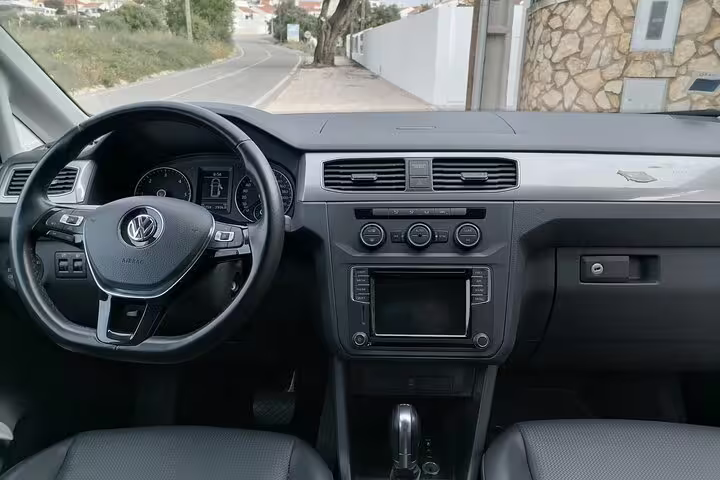 Interior view of a modern Volkswagen dashboard, highlighting comfort and style for private transfers in Faro Albufeira Alvor Seville Lisbon Lagos.