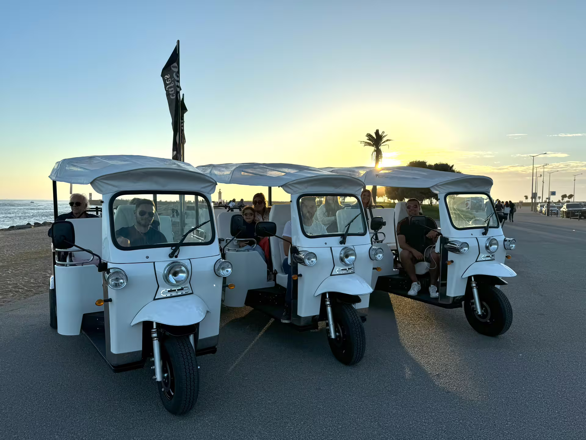 White tuk tuks lined up at sunset for a private tour to the historic center, offering a unique cruise shore excursion experience.