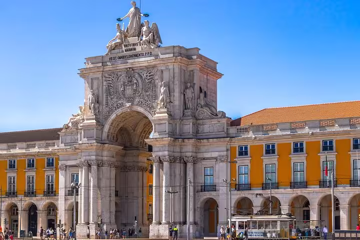 Explore Lisbon's iconic Rua Augusta Arch on a private walking tour, showcasing stunning architecture and vibrant city life.