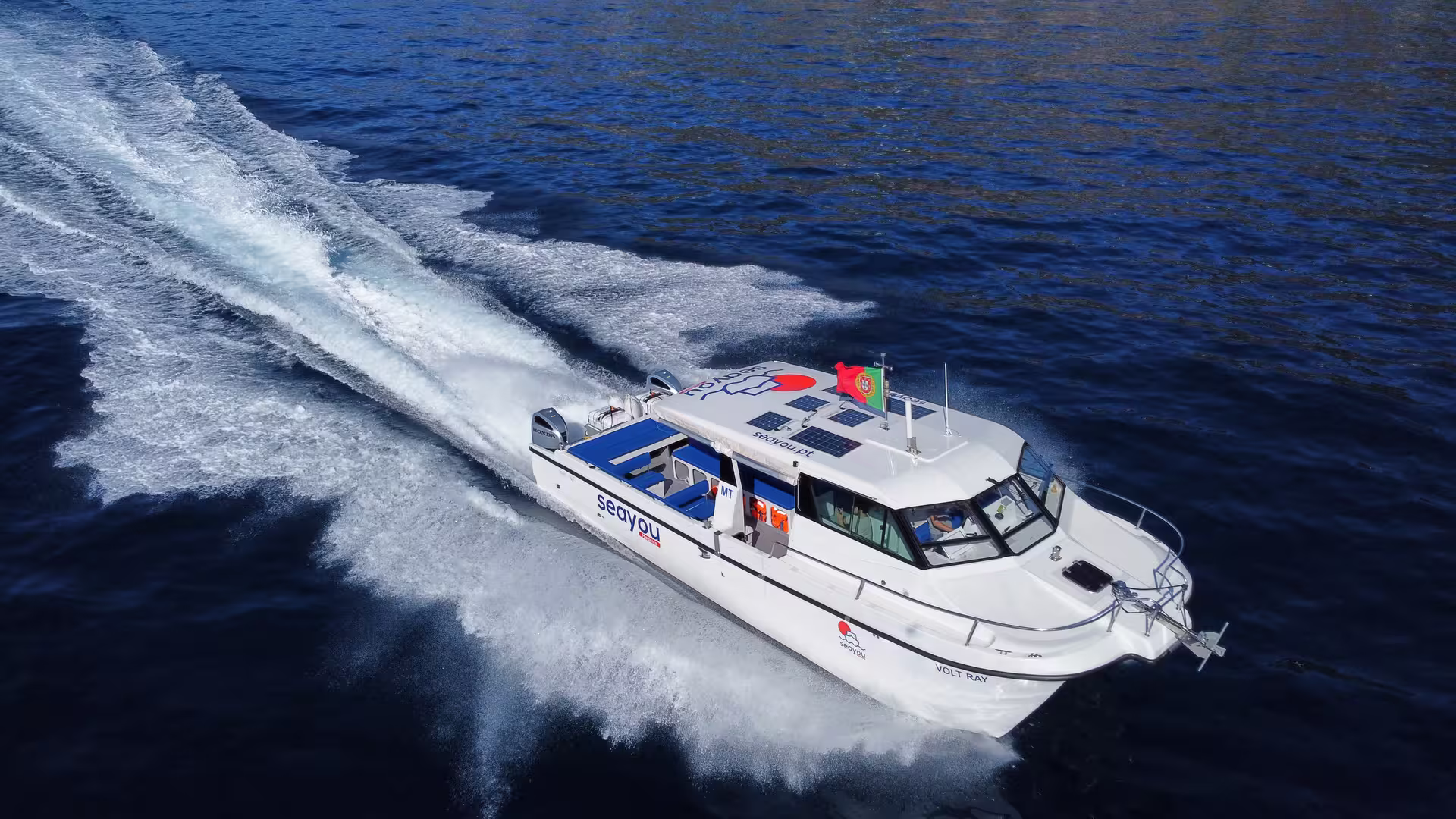 High-speed private yacht cruising through deep blue ocean waters, perfect for a sunset adventure.
