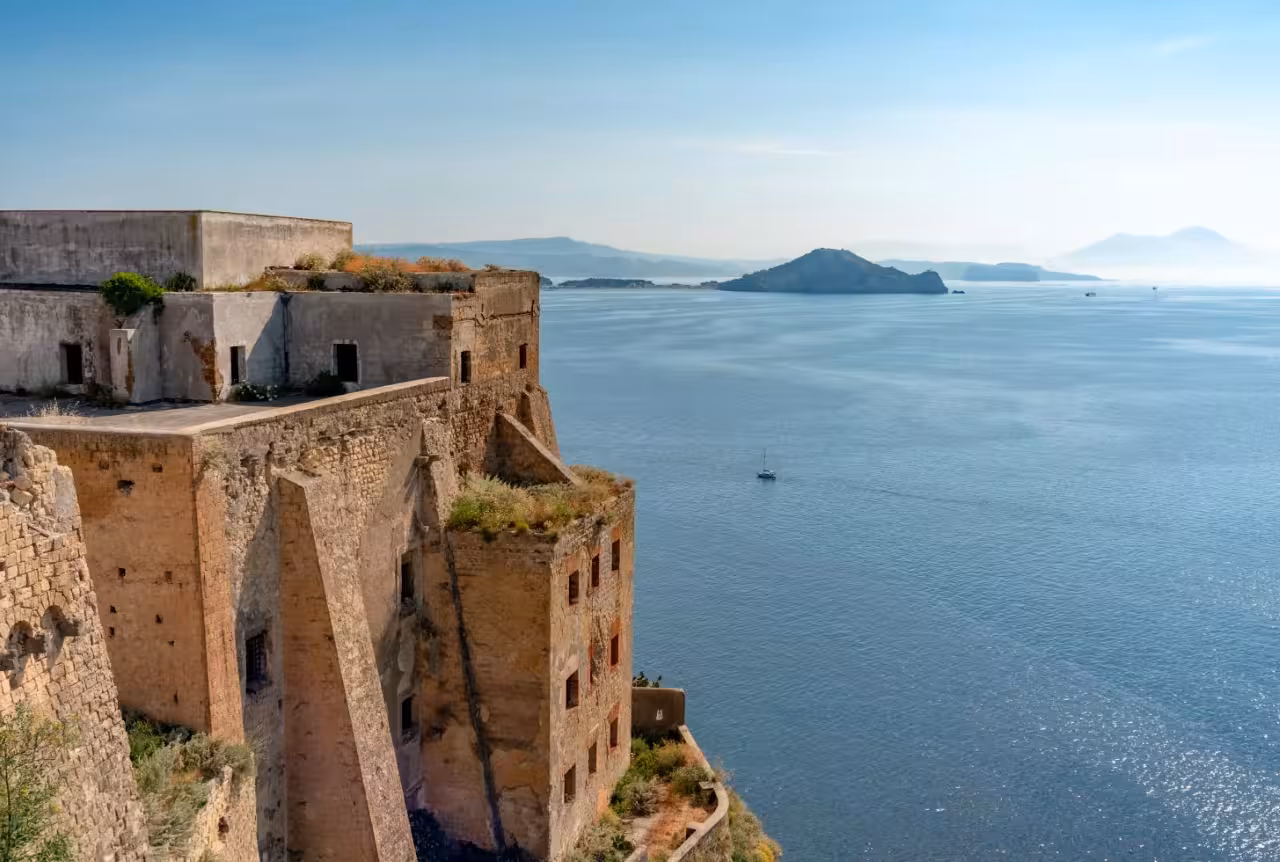 Terra Murata fortress cliffs overlooking the Bay of Naples on a Procida boat tour with hotel pick-up and sea views