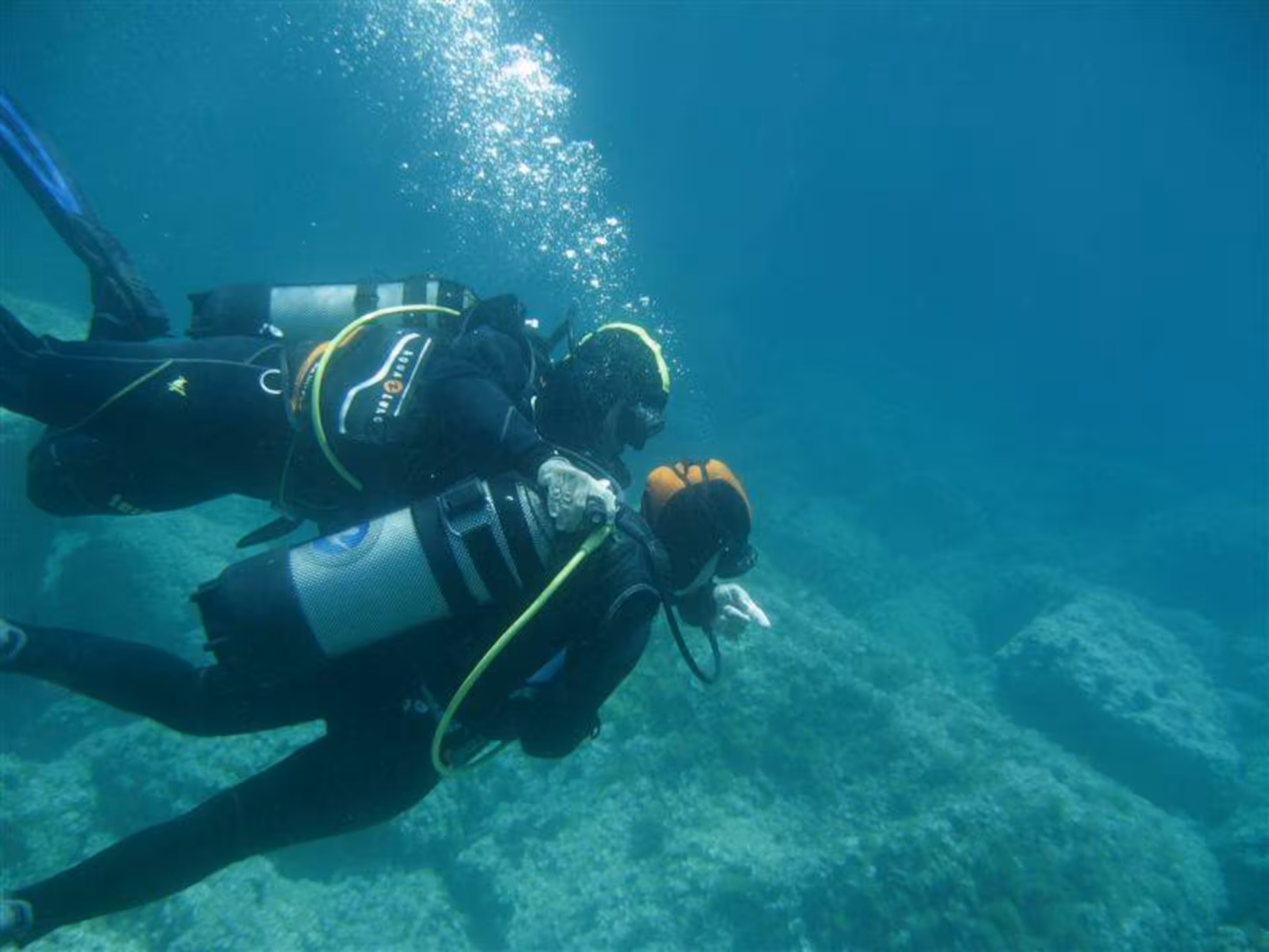 Two professional divers exploring underwater landscapes at Capo Caccia, Alghero.