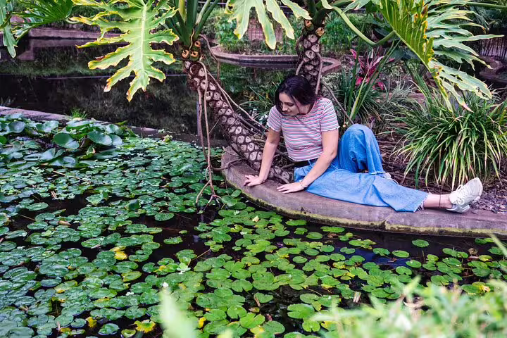 Lifestyle photo session in Tenerife botanical garden by lily pond with professional photographer, natural poses