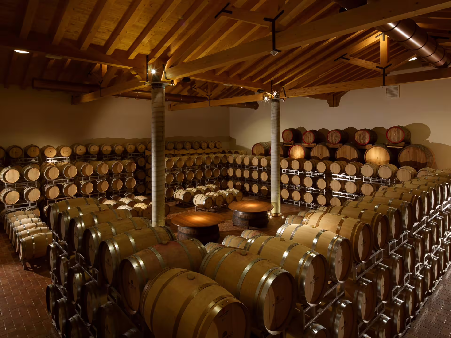 Barrel room filled with oak casks at a Prosecco winery near Venice, ideal for wine tasting tours.