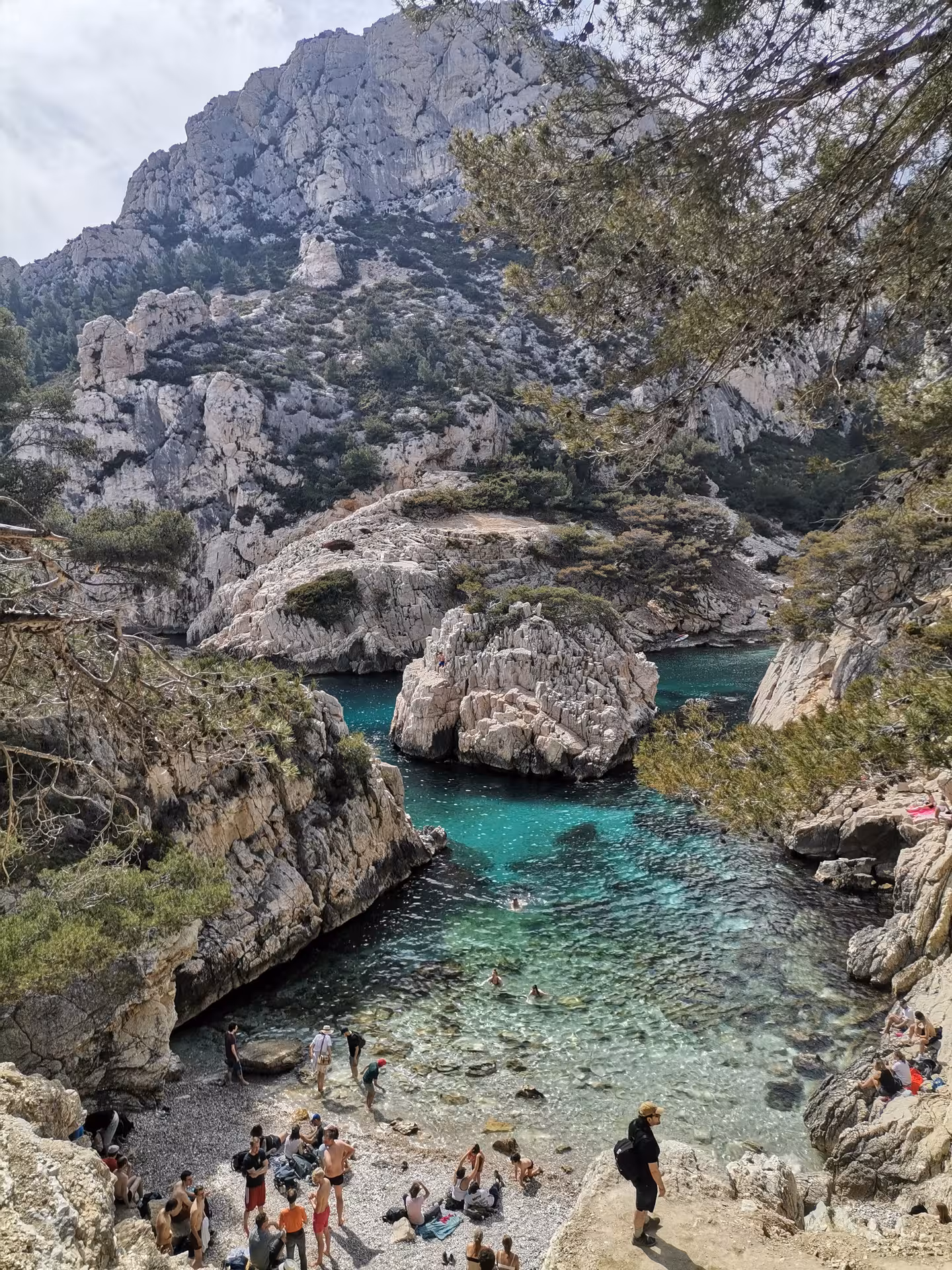 Turquoise calanque cove framed by limestone cliffs on Provence hiking getaway along the Mediterranean coast