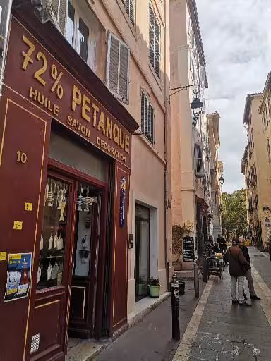 Narrow Provençal street with local boutique in Marseille, capturing authentic culture on the 14-day Christian tour