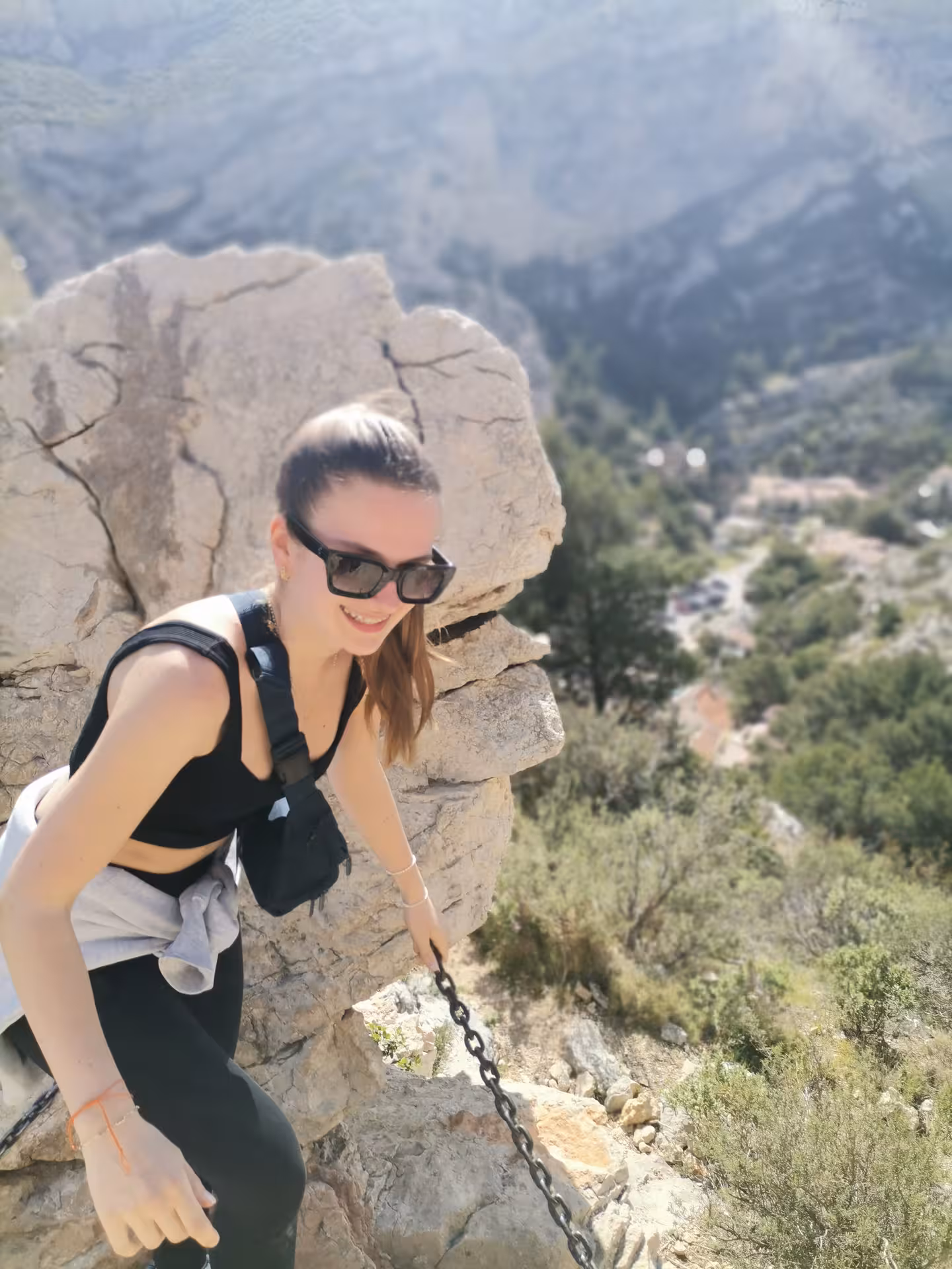Hiker climbing rocky limestone path with chain, scenic Provence mountains on 11-day guided hiking tour