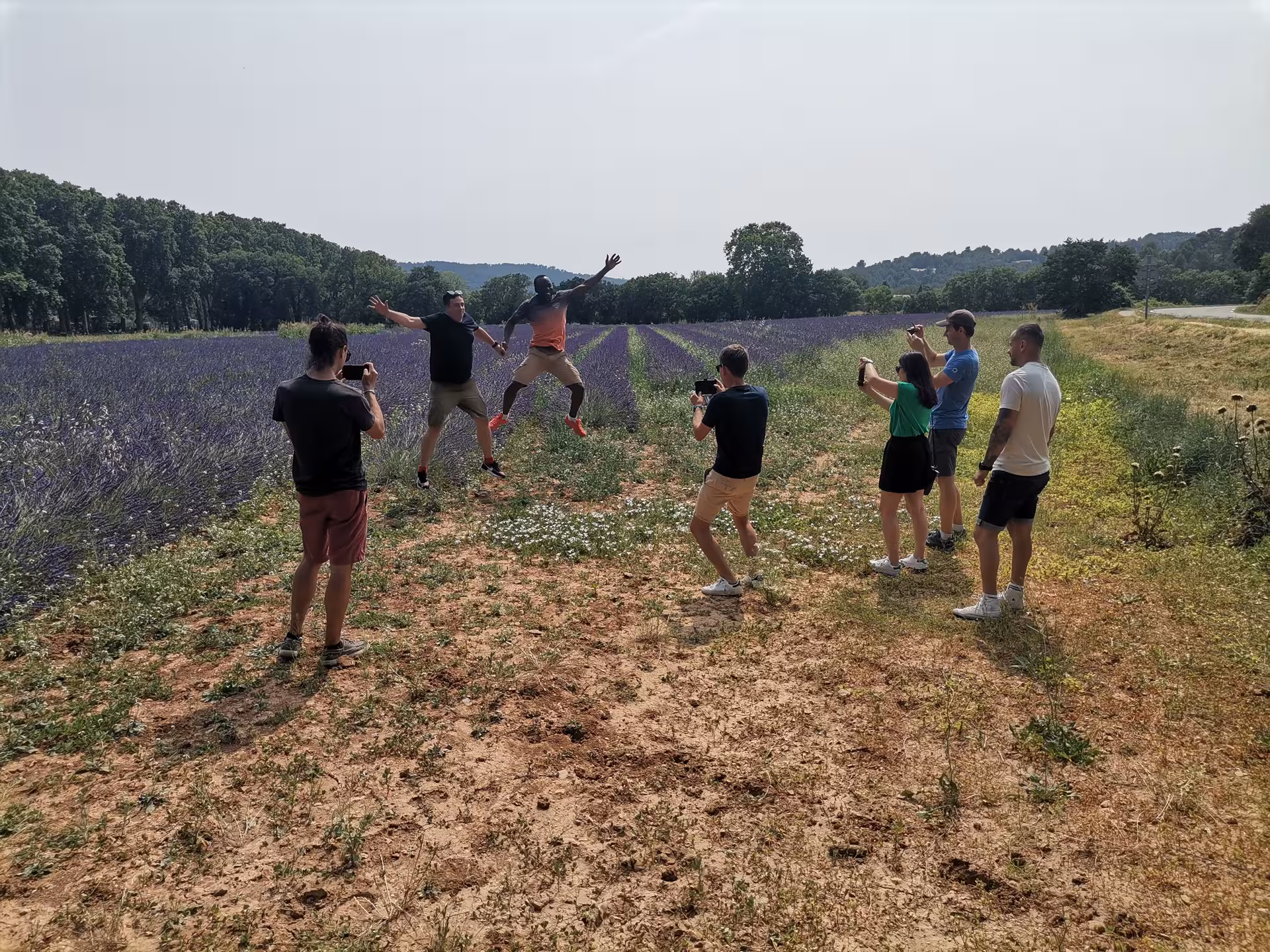 Travelers pose in a Provence lavender field on a Coteaux d'Aix-en-Provence wine tour near Sainte-Victoire