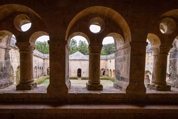 Stroll through the ancient cloisters of a Provence monastery, capturing the essence of French medieval architecture.