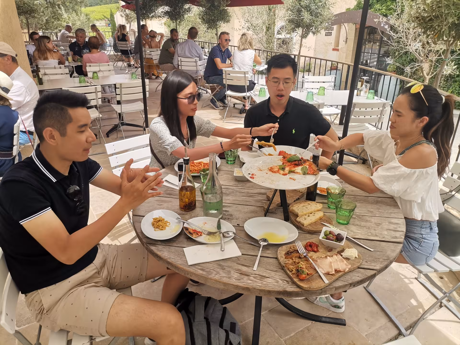 Guests enjoying Provençal lunch and wine tasting on terrace, Coteaux d'Aix-en-Provence tour near Sainte-Victoire