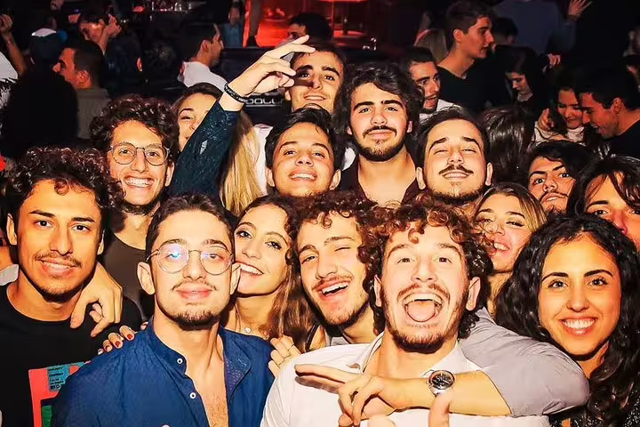 A lively group of young adults enjoying a night out on the Pub Crawl Madrid by Mad Party Crew, capturing the vibrant nightlife.