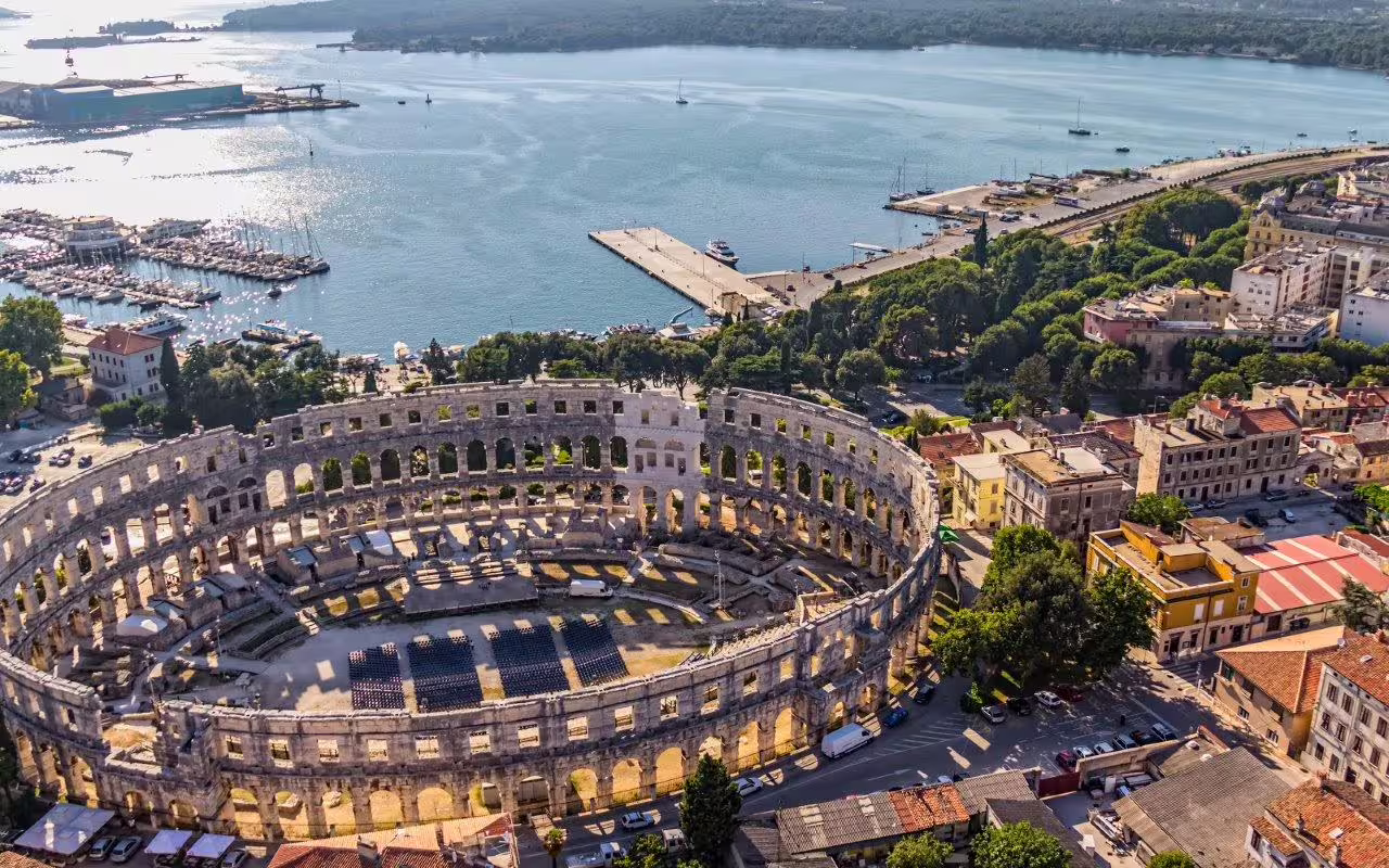 Aerial view of Pula Arena by the Adriatic marina, a highlight on a 15-day Croatia self-drive tour