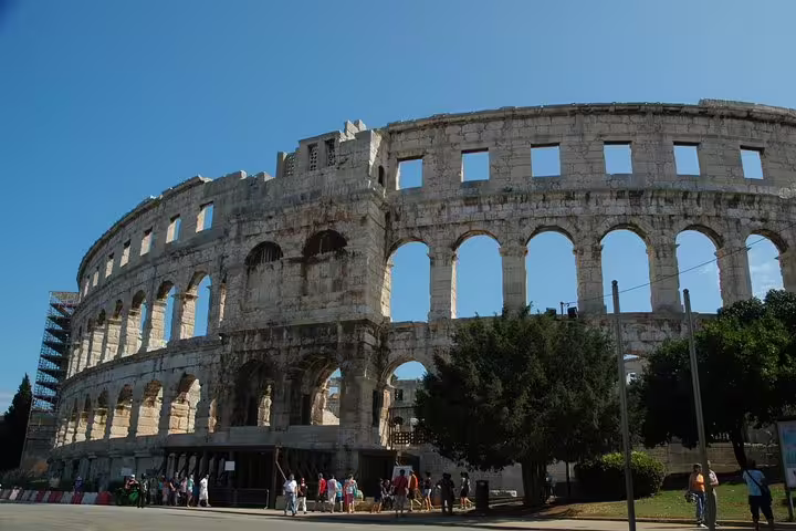 Exterior view of Pula Arena Roman amphitheater in Croatia, with visitors entering on admission ticket