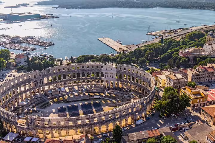 Aerial view of Pula Arena amphitheater by Pula harbor, Croatia, popular attraction for skip-the-line admission tickets