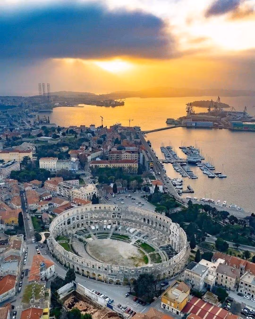 Aerial view of Pula Arena amphitheatre and marina at sunset, key stop on Magical Istria Pula & Rovinj from Zagreb