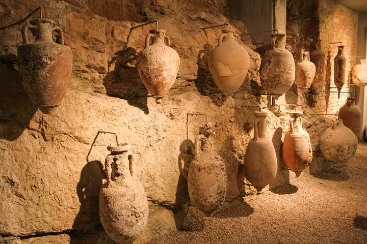 Ancient Roman amphorae display inside Pula Arena underground tunnels, included with Pula Arena entry ticket