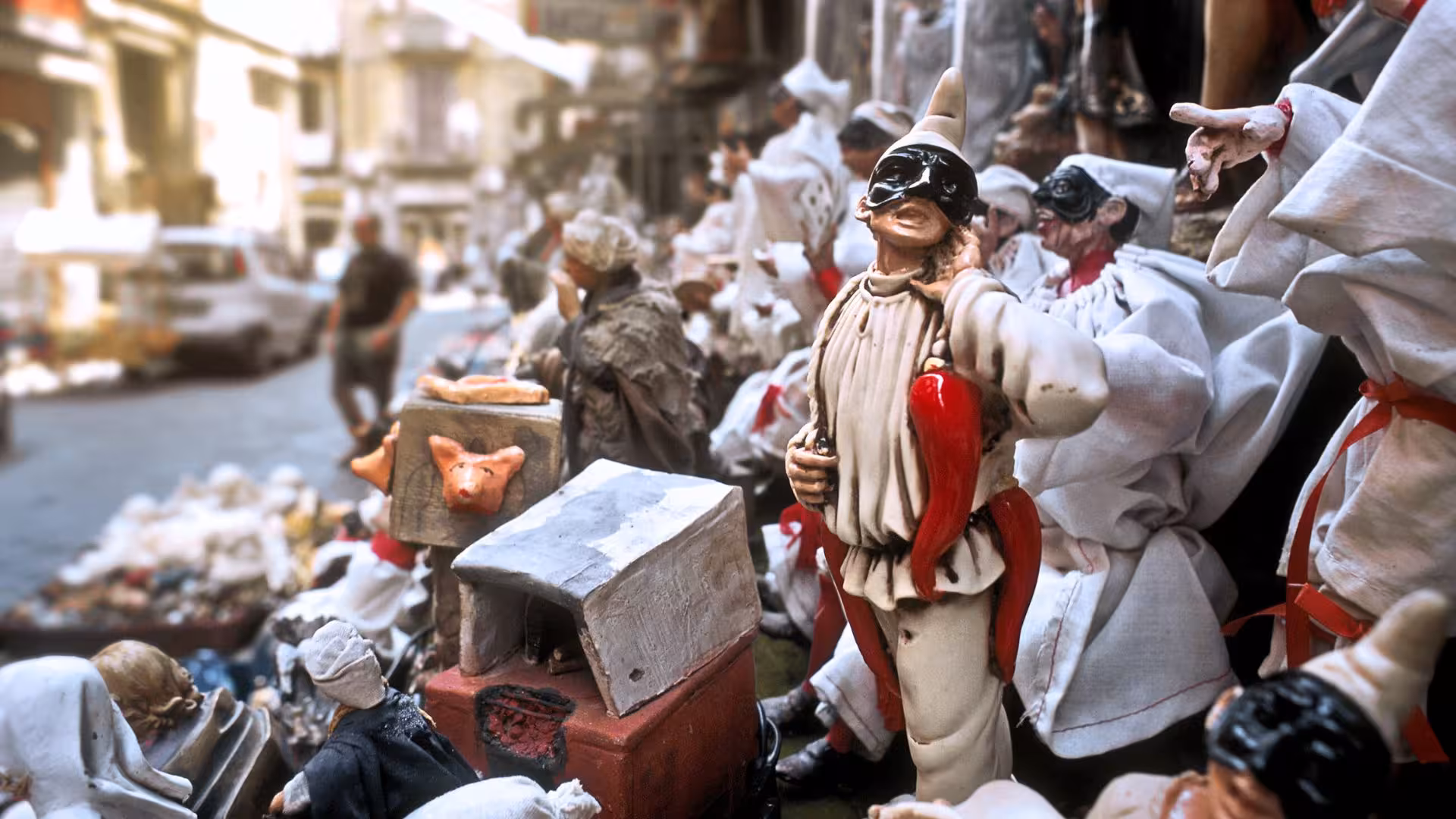Traditional Pulcinella figurines on Spaccanapoli street, highlighting Naples' rich cultural heritage.