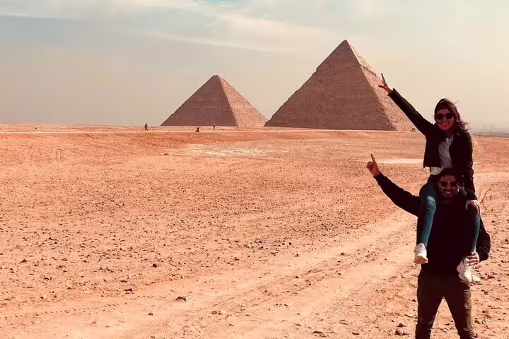 Travelers posing by the Pyramids of Giza on a 2-day Cairo and Alexandria tour from Port Said shore excursion