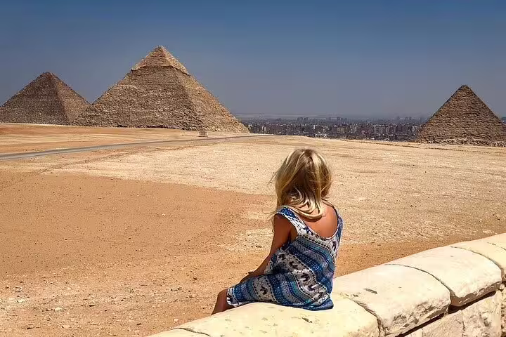 Traveler overlooking the Pyramids of Giza on a Cairo day tour by bus from Sharm El Sheikh, Egypt