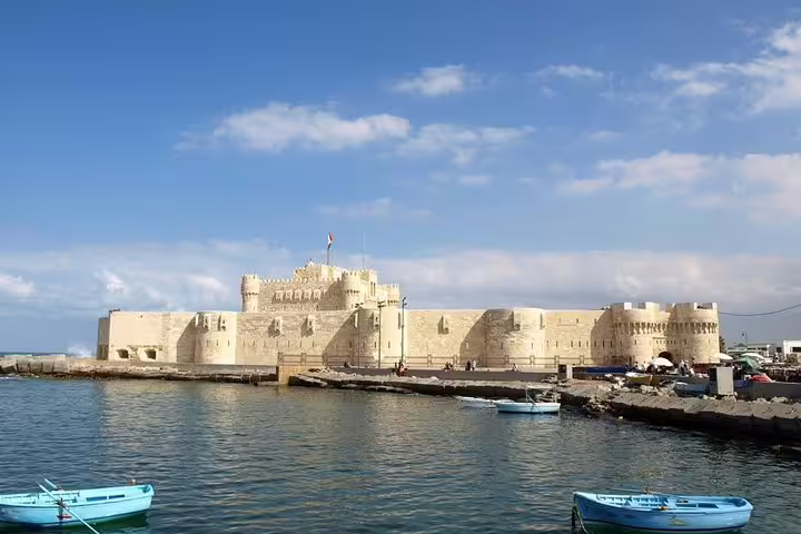 Qaitbay Citadel on Alexandria harbor with fishing boats, highlight stop on private day tour from Cairo