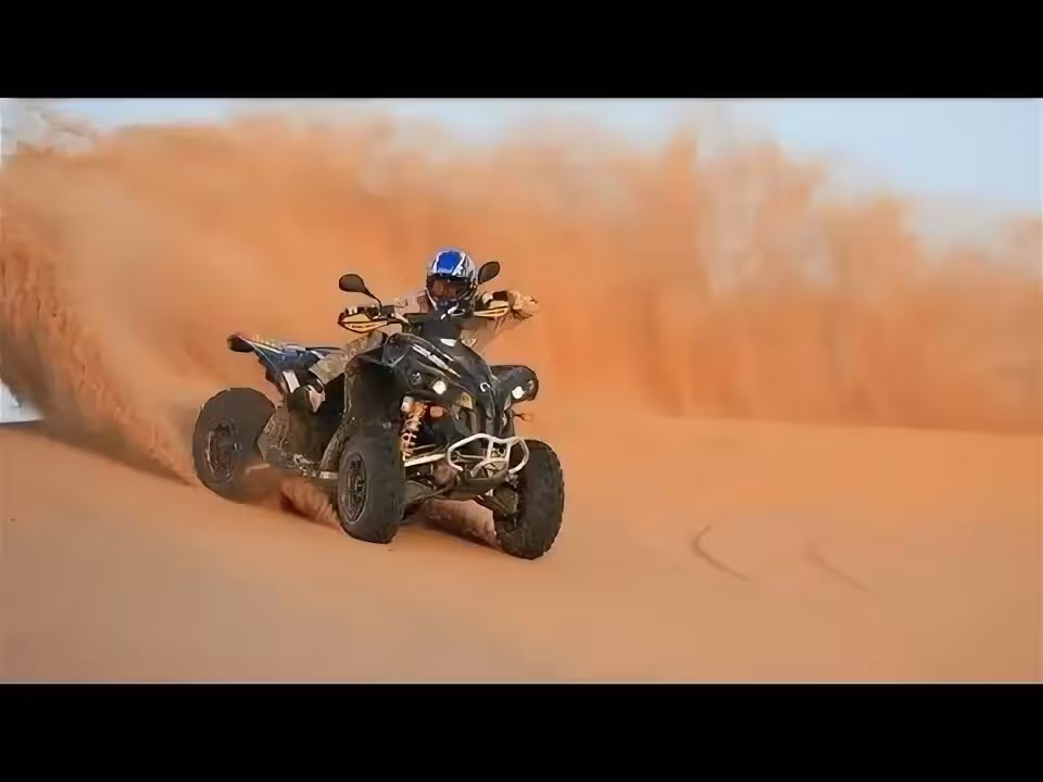 Rider performing thrilling quad bike maneuver, kicking up sand in the expansive Merzouga Erg Chebbi Desert dunes.