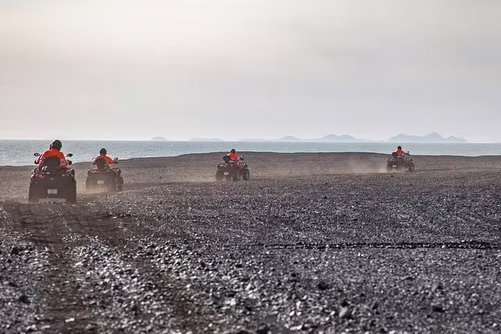 Group riding ATVs along Makadi Bay coast, sea side private quad safari with Red Sea views and desert terrain