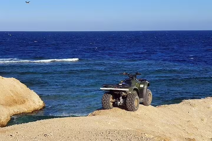 ATV parked on Makadi Bay shoreline overlooking the Red Sea, sea side private quad tour with coastal views