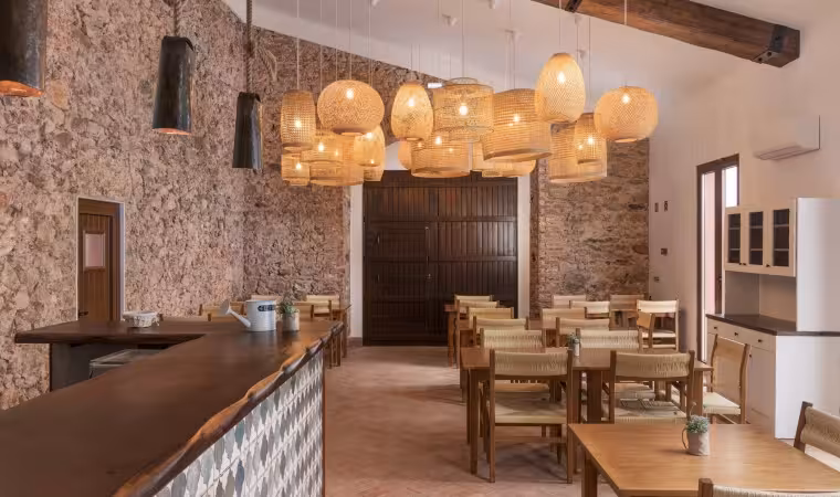 Rustic restaurant with wooden tables and warm lights where riders enjoy lunch on a full day quad adventure tour