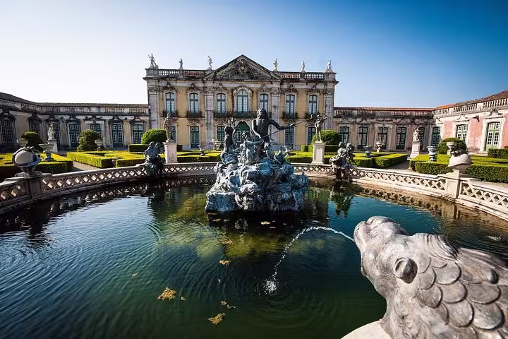 Elegant palace with ornate gardens and a central fountain at Queluz, featured in the Mafra, Ericeira, and Queluz private tour.