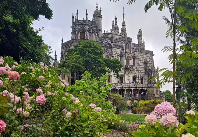Discover the enchanting Quinta da Regaleira Palace nestled among vibrant gardens in Sintra, Portugal.