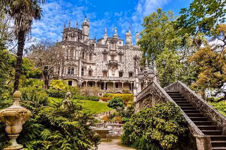 The enchanting Quinta da Regaleira in Sintra, surrounded by lush gardens and ornate Gothic architecture.