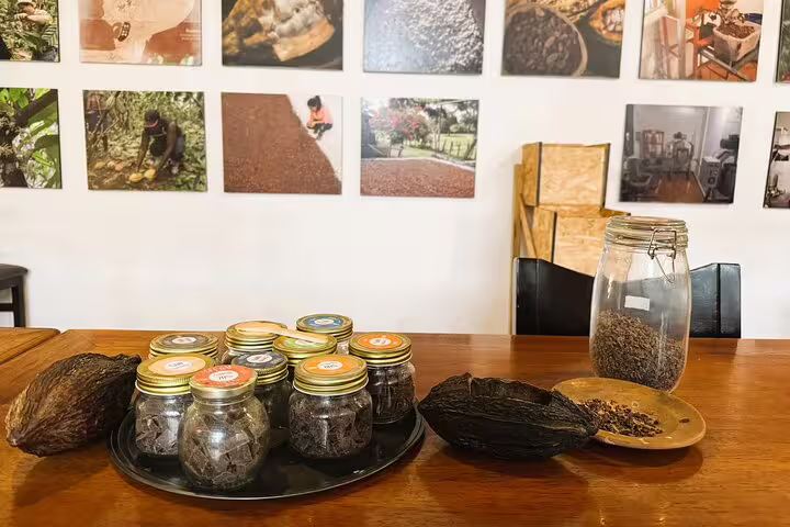 Jars of cacao and cocoa pods on a table in Quito's hidden gem food and cacao tasting tour, showcasing artisanal flavors.