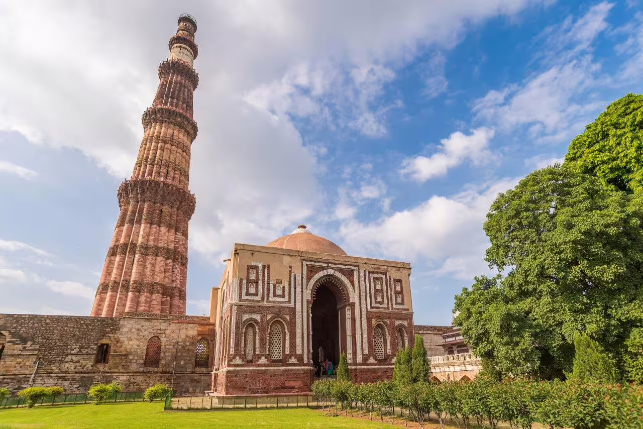 Explore the iconic Qutub Minar against a vibrant blue sky on the Magical Rajasthan 9-day tour.
