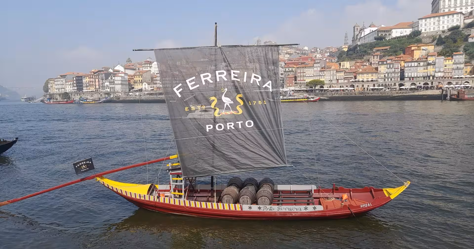 Ferreira rabelo boat on the Douro River in Porto, classic riverside view on 7-day Lisbon to Porto tour
