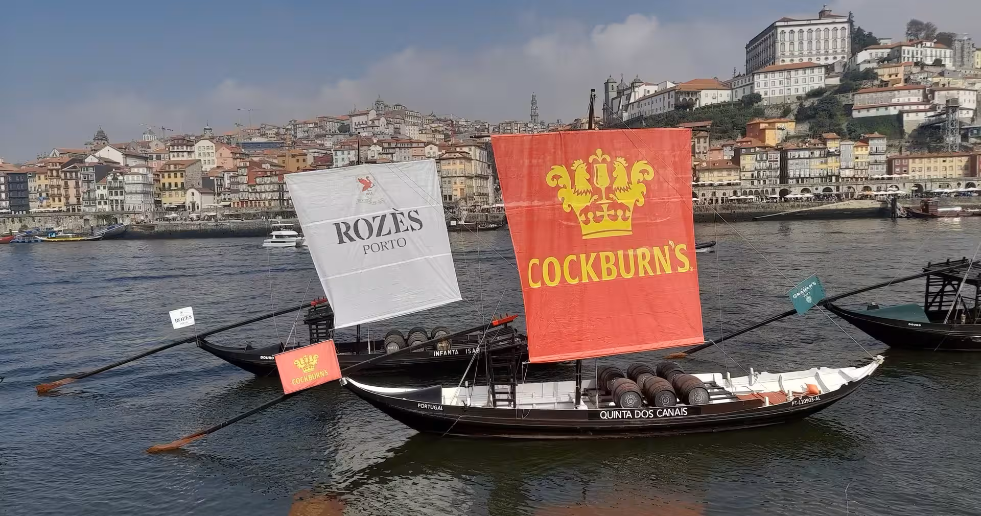 Traditional rabelo boats on Porto’s Douro River, iconic view on 7-day Portugal tour from Lisbon to Porto