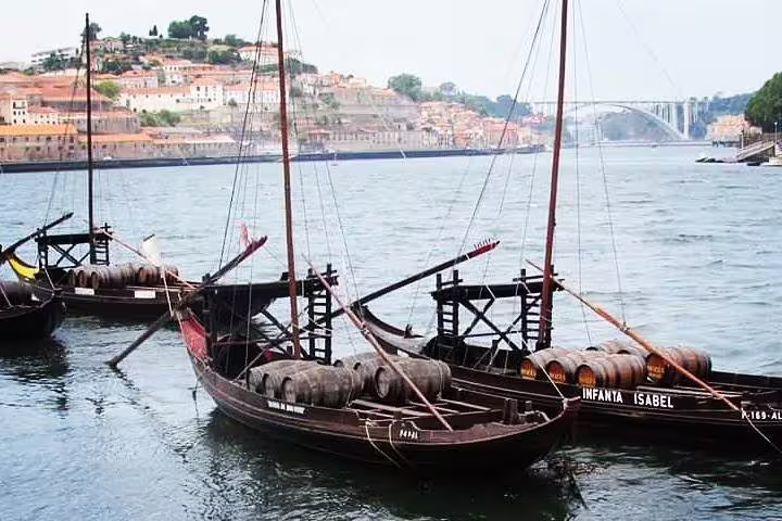 Traditional Rabelo boats on Douro River, perfect for Porto river cruise and wine tasting tour experience.
