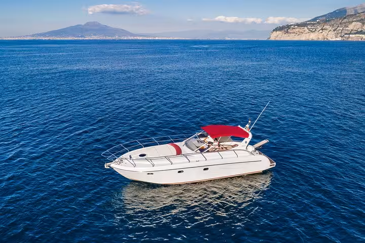 Luxury Raffaelli Shamal 40 yacht cruising near Capri with stunning coastal views and blue waters from Sorrento.