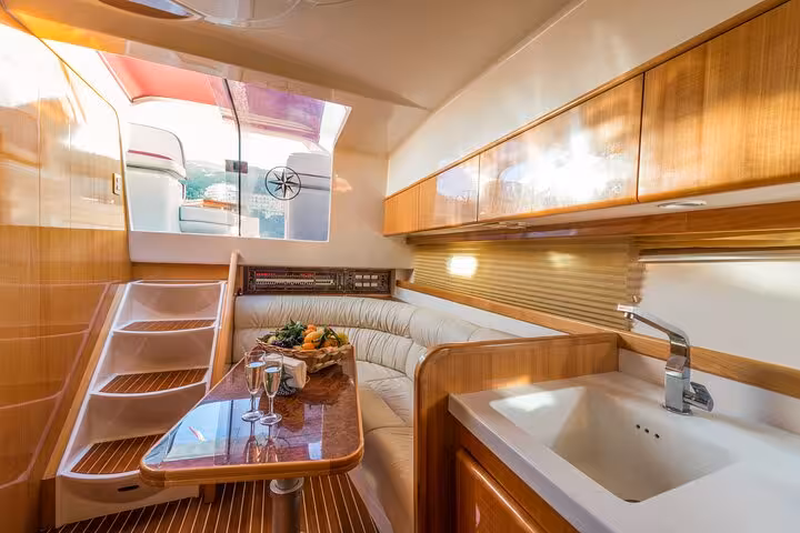 Elegant dining area on the Raffaelli Shamal 40 yacht featuring a plush seating area and dining set, ideal for a Capri tour.