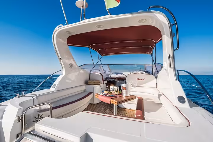 Elegant interior of Raffaelli Shamal 40 yacht with comfortable seating and refreshments, ideal for luxury Capri tour.