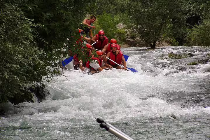 Rafting team tackles foaming Cetina River rapids on guided tour with transfer from Makarska Riviera
