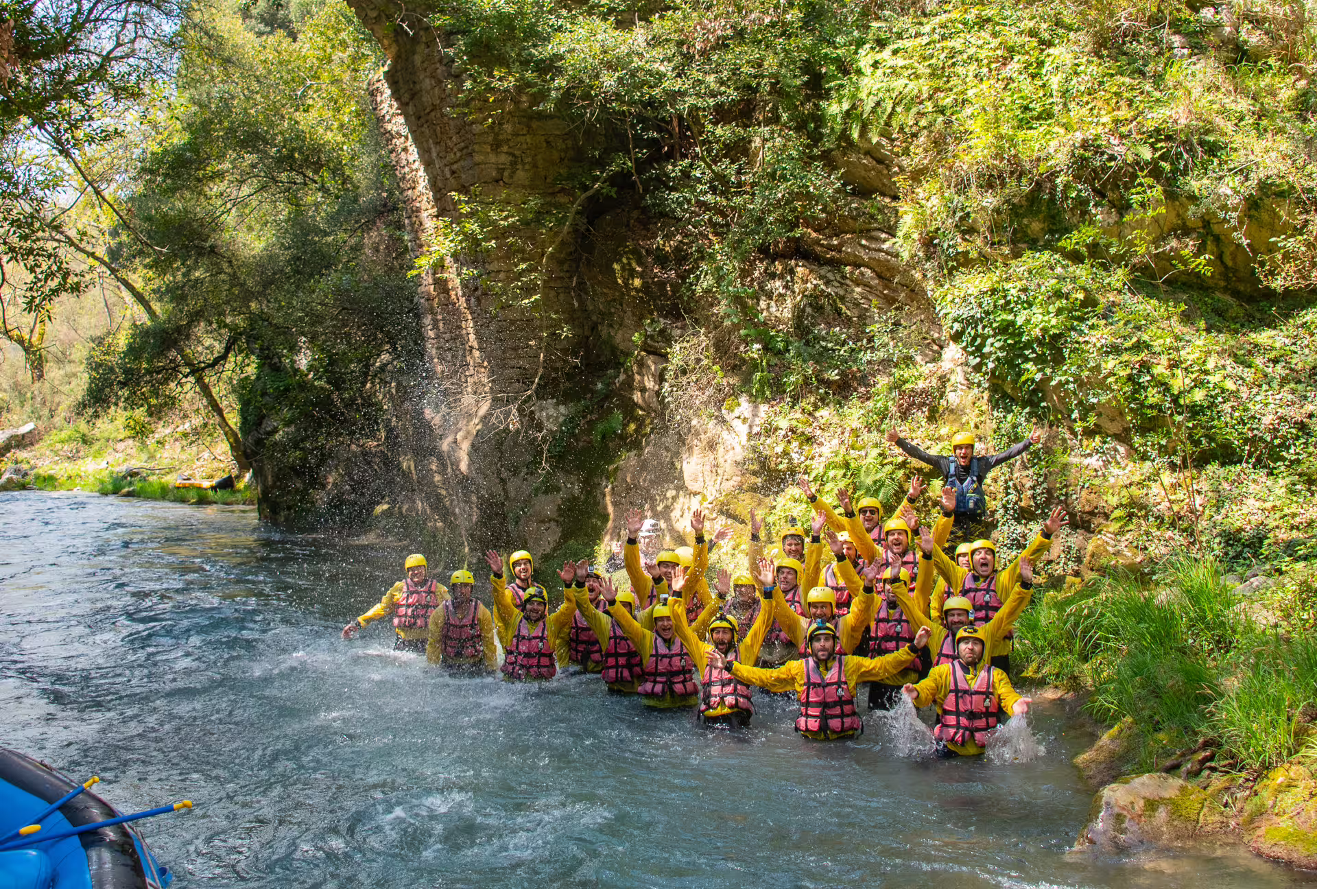 Group of rafters cheering in river canyon during Lousios and Alfeios rafting adventure in Arcadia, Peloponnese