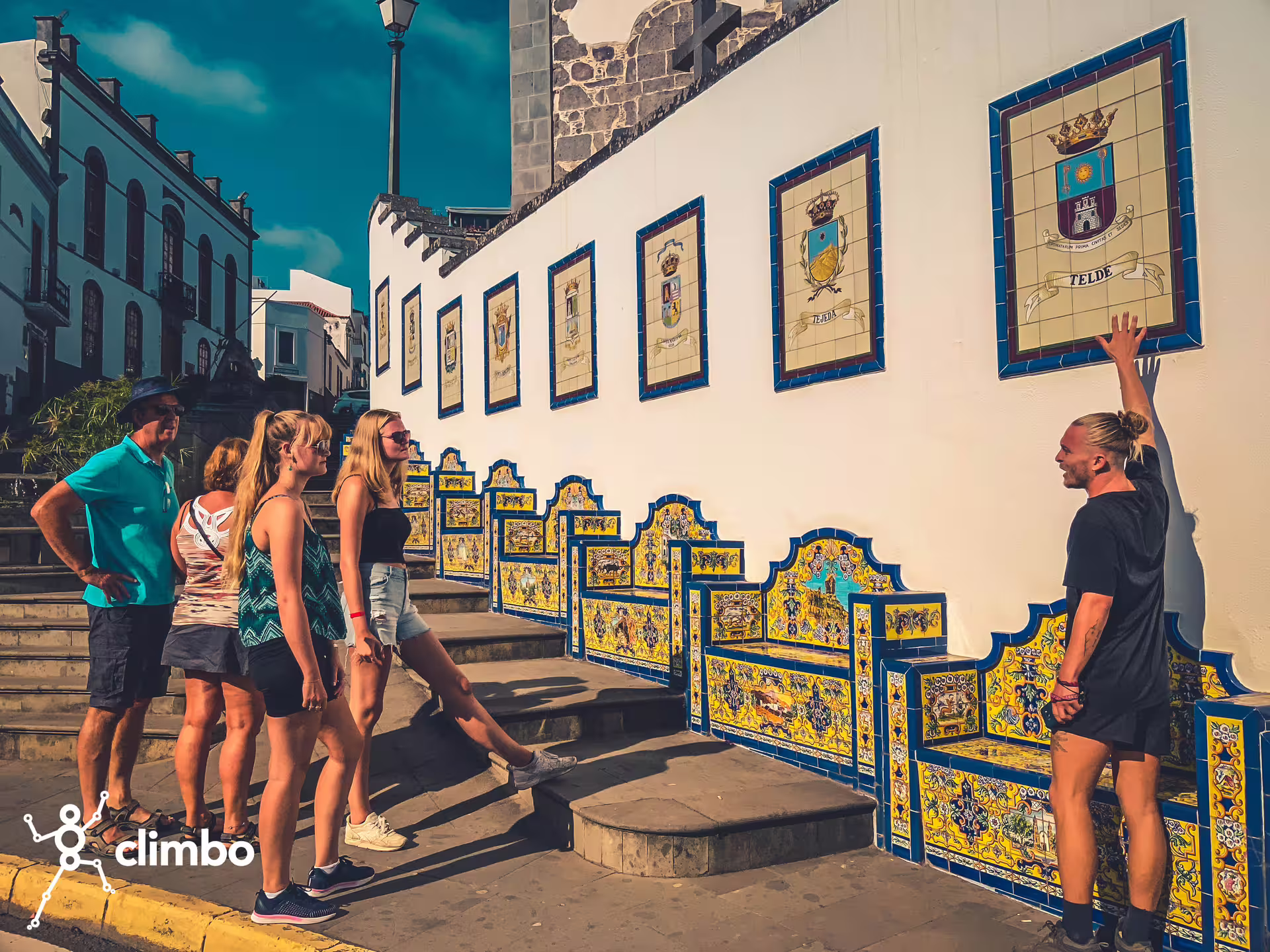 Tourists admiring colorful murals on a historic wall during the Rainforest Tour's cultural exploration segment.