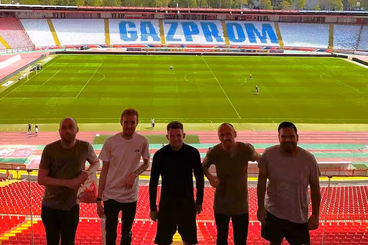 Group photo at Rajko Mitic Stadium overlooking the pitch on a Belgrade live football match experience with local
