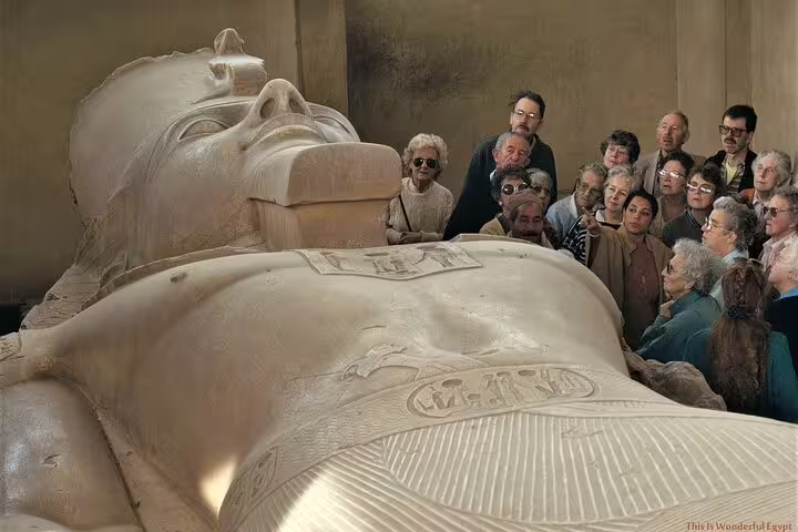 Visitors viewing the giant colossus of Ramses II at Memphis museum on Dahshur Pyramid and Memphis City Tour