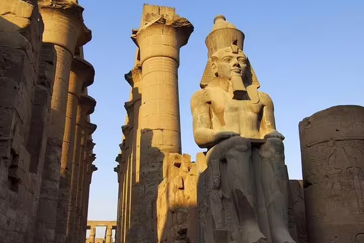 Colossal seated Ramses II statue at Luxor Temple, key stop on private Luxor day tour from Cairo by plane