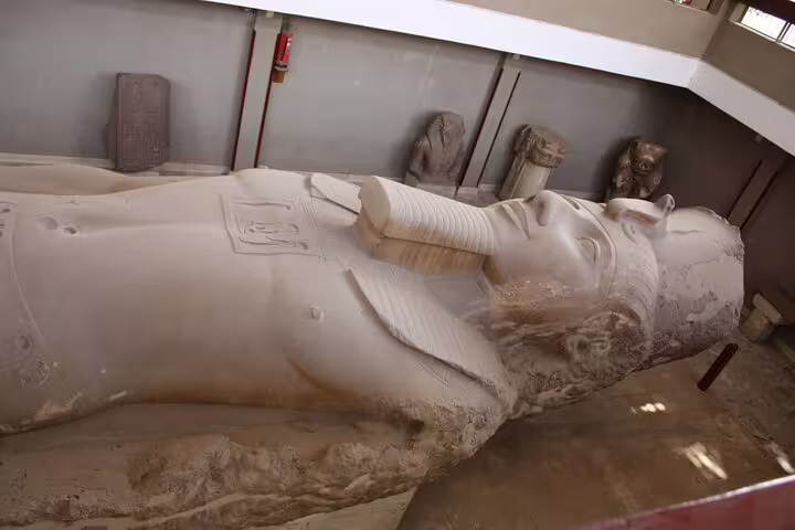 Colossal Ramses II limestone statue inside Memphis museum, a highlight of Dahshur Pyramid and Memphis tour