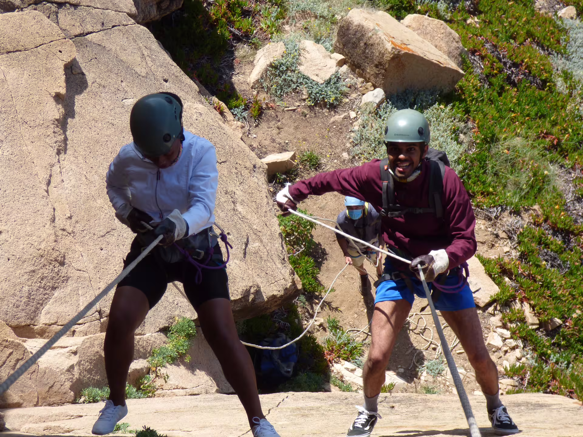Adventurers enjoy a thrilling rappelling circuit in Sintra, navigating rocky terrain with ropes and safety gear amidst scenic landscapes.