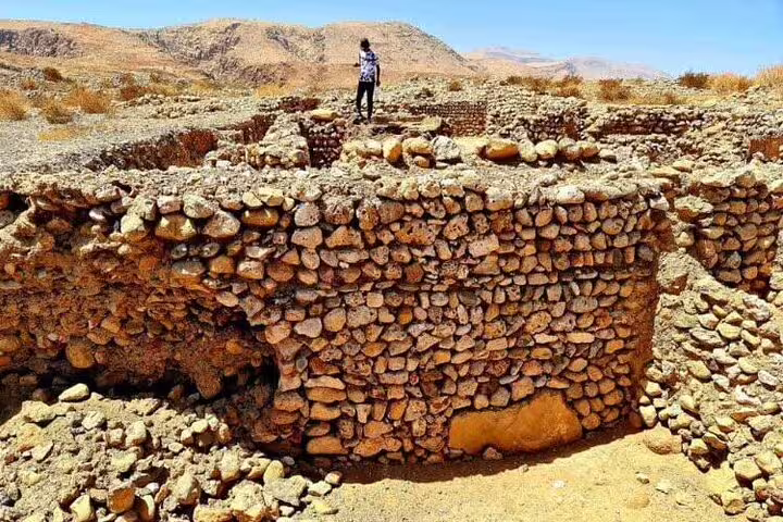 Ancient stone ruins under clear blue skies, perfect for Ras Al Hadd historical exploration tours.